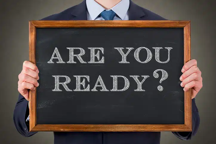 Man holding sign asking "are you ready" as in are you ready as a leader to deliver an important and intentional communication?