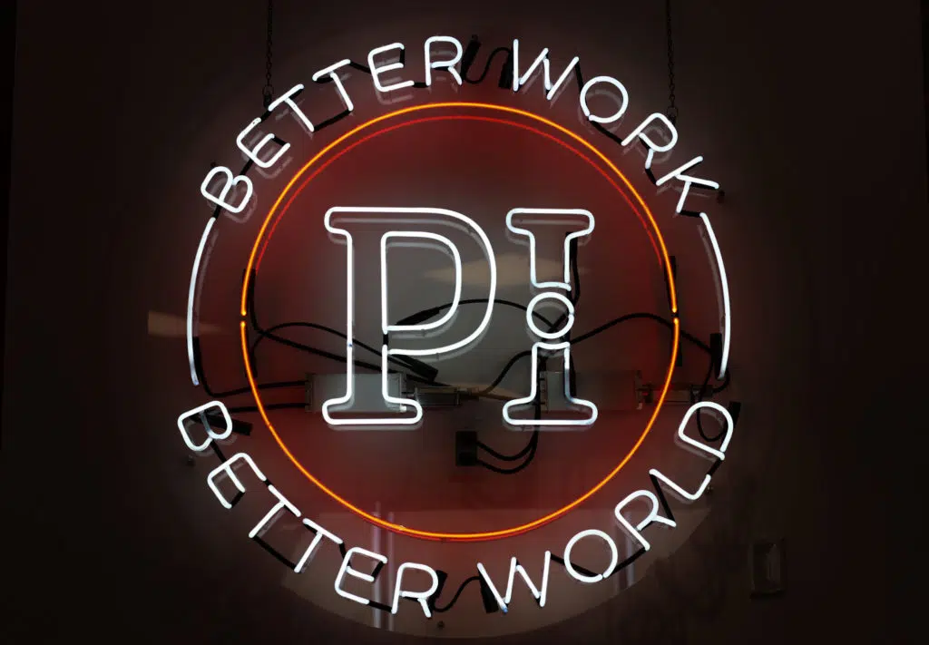 Predictive Index neon logo with Better Work & Better World statement. The Predictive Index is the premier talent optimization provider.